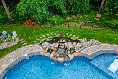 Simbi G - Cream Ridge, NJ - A bird's eye view of a backyard with a swimming pool and landscaping