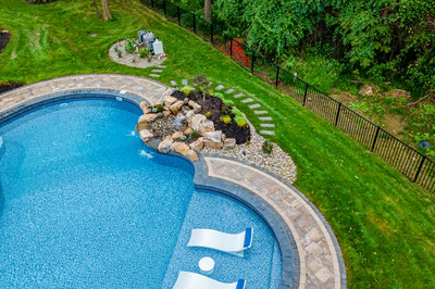 Simbi H - Cream Ridge, NJ - A backyard with a swimming pool surrounded by lush green grass and trees