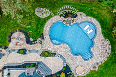 Simbi I - Cream Ridge, NJ - A bird's eye view of a backyard with a swimming pool surrounded by lush greenery