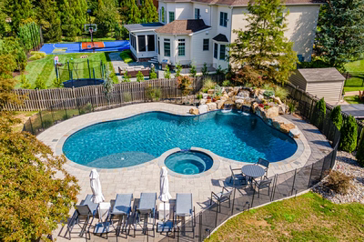 Sipi I - Pikesville, MD - A large backyard with a swimming pool and a basketball court.