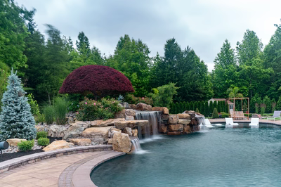 Sisiyi N - Manalapan, NJ - A beautiful backyard with a pond and waterfall surrounded by lush greenery