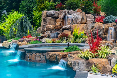 Spray C - Franklinville, NJ - A colorful garden with a waterfall and a swimming pool surrounded by lush greenery
