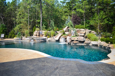 Sutherland C - Monroe, NJ - A swimming pool surrounded by lush greenery and a waterfall feature