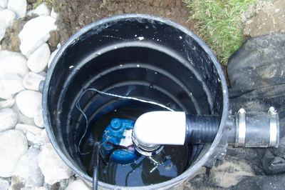 Swiftwater H - Pennsylvania - A bucket filled with water and a small device inside of it, surrounded by rocks and grass
