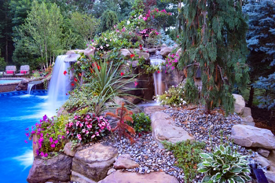 Tama H - Manalapan, NJ - A beautiful garden with a waterfall surrounded by flowers and rocks