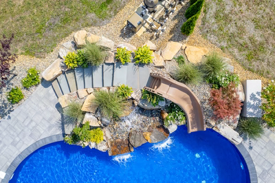 Tamolitch I - Millstone, NJ - A bird's eye view of a backyard with a swimming pool and a water feature