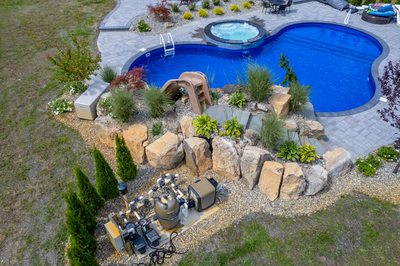 Tamolitch J - Millstone, NJ - A bird's eye view of a backyard with a swimming pool surrounded by landscaping and rocks