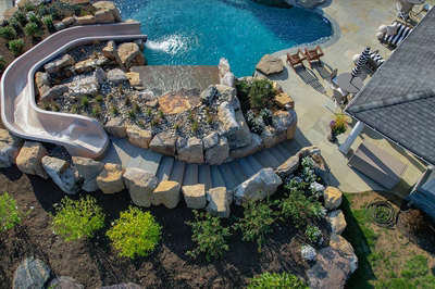 Tchupala P - Medford, NJ - A bird's eye view of a backyard with a water feature and a water slide