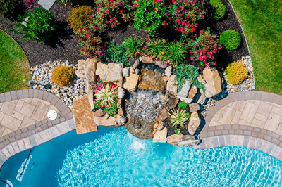 Thika H - Berlin, NJ - A bird's eye view of a backyard with a swimming pool and a waterfall