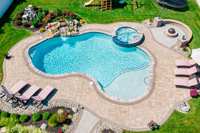 Thika L - Berlin, NJ - A backyard with a swimming pool surrounded by lush green grass and landscaping