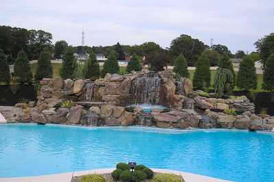 Tiger A - Sicklerville, NJ - A large swimming pool with a waterfall feature in the middle of it