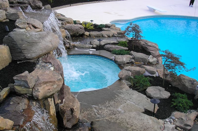 Tiger E - Sicklerville, NJ - A large swimming pool surrounded by rocks and a waterfall.