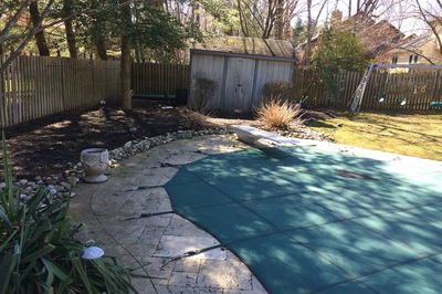 Tully A - Voorhees, NJ - A backyard with a wooden fence and a green tarp covering the ground.