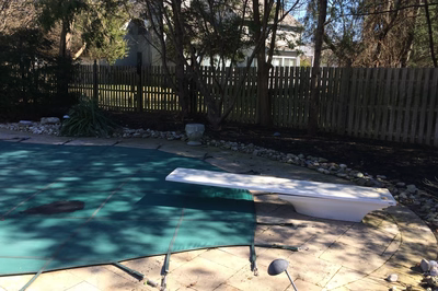 Tully C - Voorhees, NJ - A backyard with a wooden fence and a green tarp covering the ground.