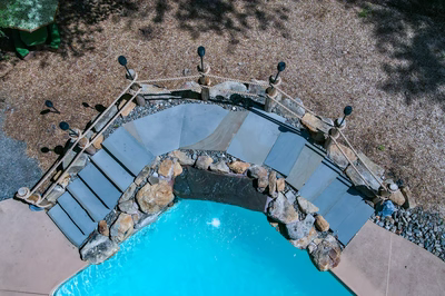Vernal O - Media, PA - A bird's eye view of a swimming pool surrounded by rocks and pebbles