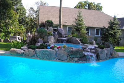 Wagner B - Media, PA - A swimming pool with a waterfall in the middle of it surrounded by rocks and plants