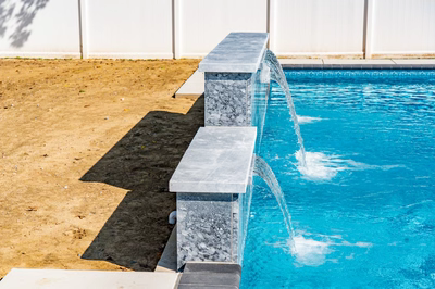 Waireinga F - Bel Air, MD - A blue swimming pool with a water feature in the middle of it