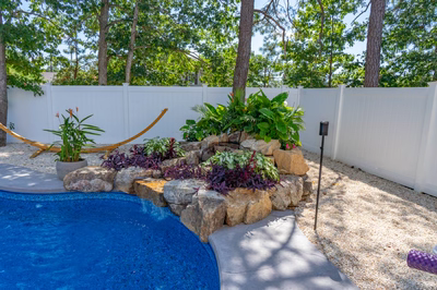 Willamette B - Barnegat, NJ - A backyard with a pool surrounded by lush greenery and a white fence