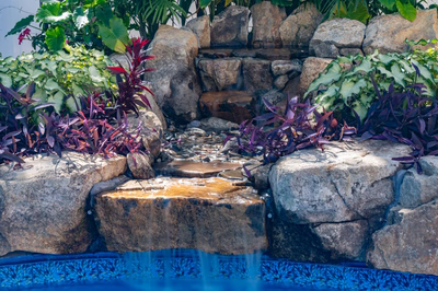 Willamette G - Barnegat, NJ - A small waterfall in a rock garden next to a swimming pool
