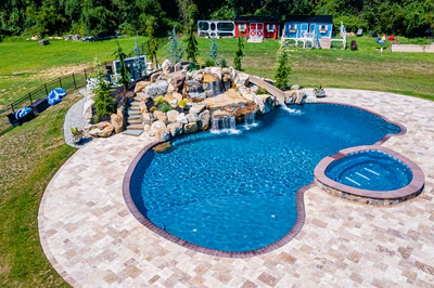 Yakso N - Mullica Hill, NJ - A large backyard with a swimming pool and a waterfall feature