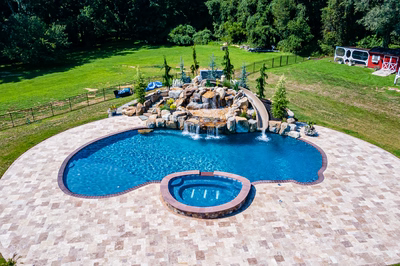 Yakso O - Mullica Hill, NJ - A large backyard with a swimming pool and a waterfall.