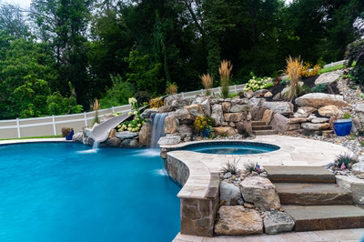 Yosemite I - Newtown Square, PA - A swimming pool with a waterfall and landscaping around it