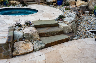 Yosemite J - Newtown Square, PA - A stone path leading to a swimming pool surrounded by rocks and plants
