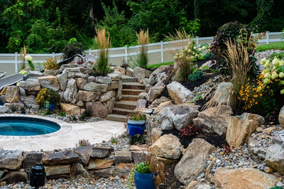 Yosemite K - Newtown Square, PA - A rock garden with a pool and a waterfall in the background