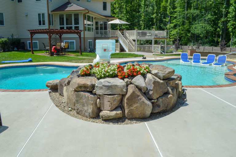 A large backyard with a swimming pool and a basketball hoop