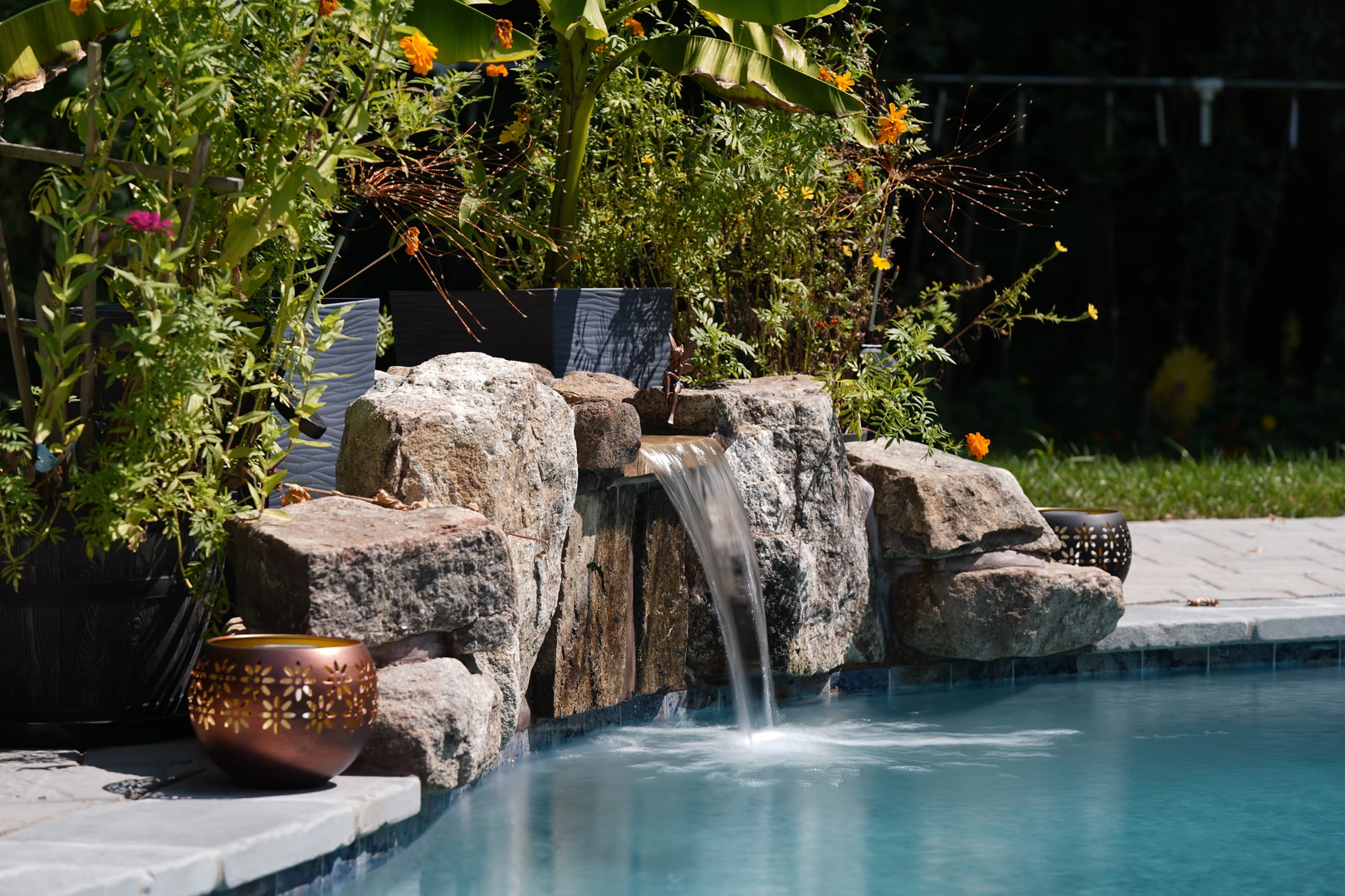 Close view of water flowing over the natural stone in a Genesis waterfall