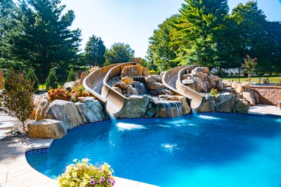 Backyard pool with a natural stone water slide and waterfall, Forest Hill, MD