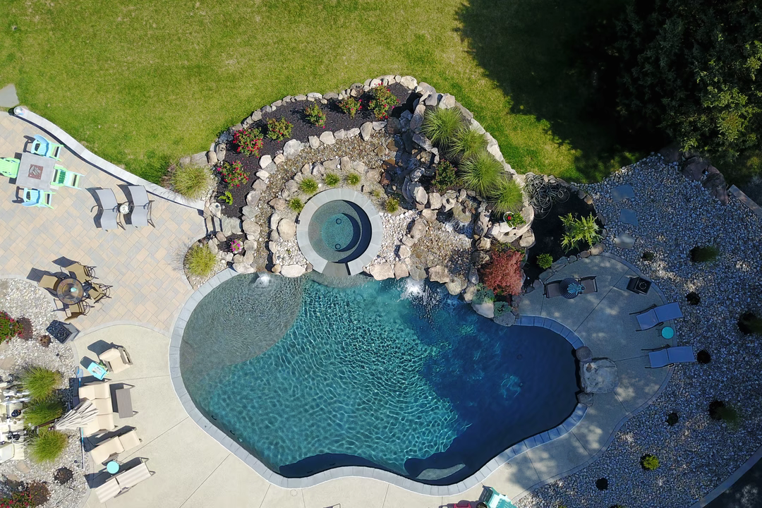 Tufa G - Medford, NJ - A bird's eye view of a backyard with a swimming pool surrounded by landscaping