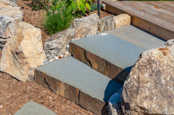 Day Z - Manasquan, NJ - A set of stone steps leading up to a wooden deck in a garden.