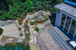 Day Z - Manasquan, NJ - A bird's eye view of a backyard with a waterfall and a wooden deck